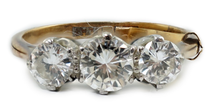 An 18ct gold, platinum and three stone diamond set ring